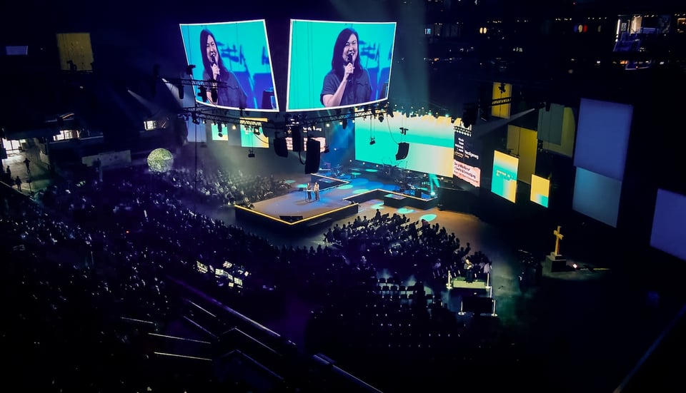 Pastor Lia preaching at Explo 25