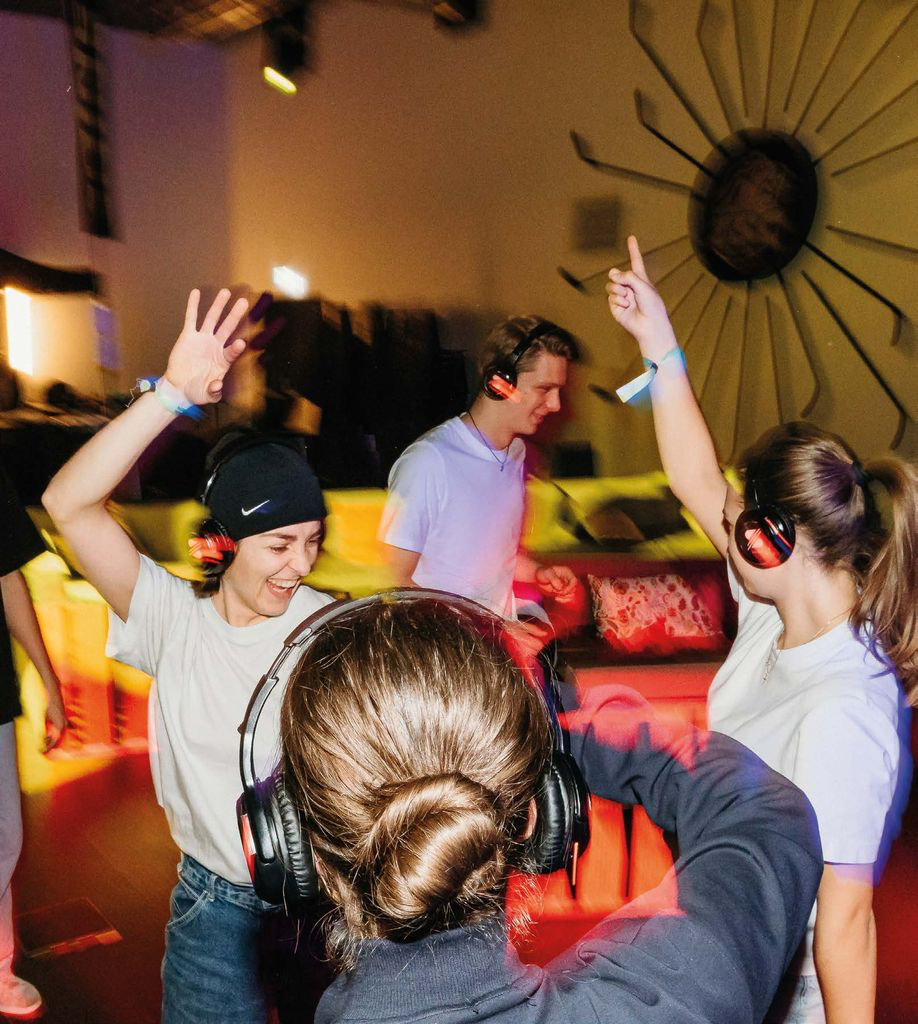 People worshiping with headphones at Heart of God Church